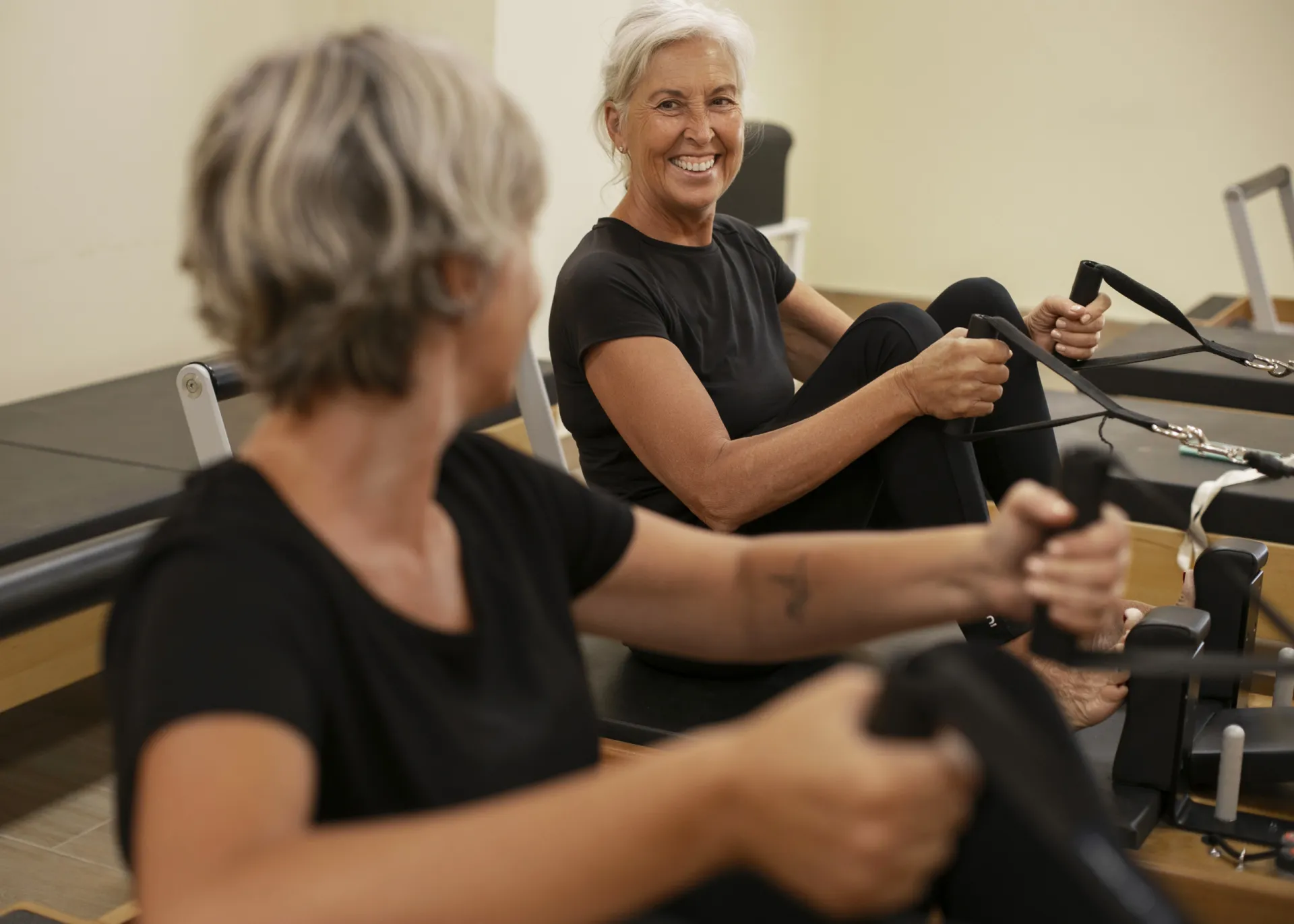 medium shot senior women pilates reformer class